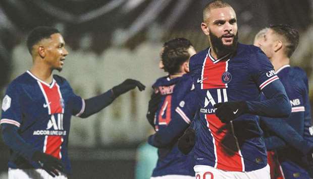 Paris Saint-Germainu2019s French defender Layvin Kurzawa (right) celebrates after scoring a goal during the French L1 match against Angers at the Raymond Kopa Stadium in Angers, western France, yesterday. (AFP)