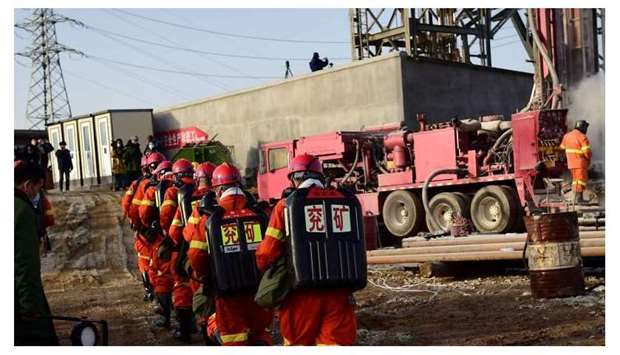 This photo taken on January 13 shows rescuers working at the site of gold mine explosion where 22 miners were trapped underground in Qixia, in eastern China's Shandong province.