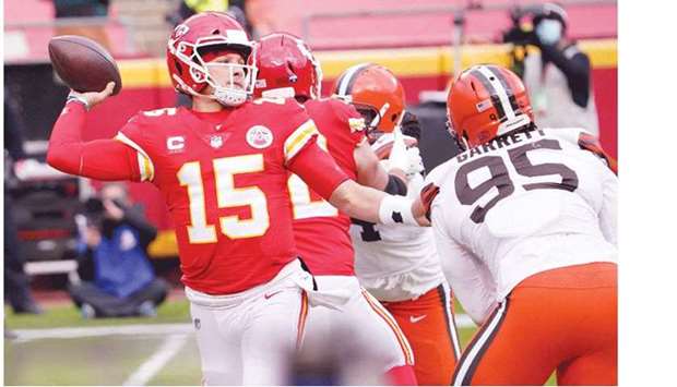 Kansas City Chiefs quarterback Patrick Mahomes (left) throws as Cleveland Browns defensive end Myles Garrett moves in during the first half in their playoff game at Arrowhead Stadium in Kansas City, Missouri. (USA TODAY Sports)