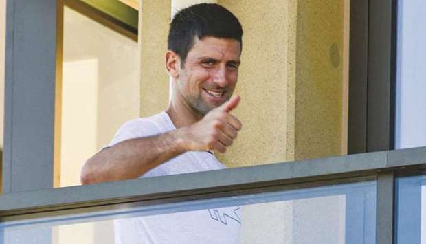 World number one tennis player Novak ?Djokovic of Serbia gestures from his hotel balcony in Adelaide yesterday.