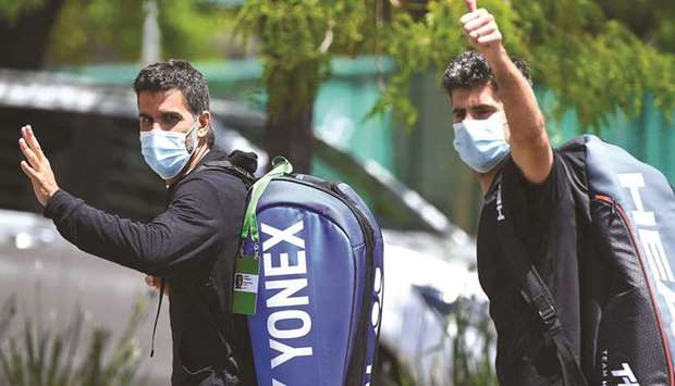 Argentine tennis player Maximo Gonzalez (L) and Italyu2019s Simone Bolelli (R) return to a tennis hotel after a training session in Melbourne yesterday.