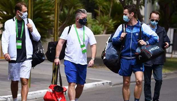 Polish tennis player Lukasz Kubot (L), trainer Hermanus Kroes (C) and Brazilian tennis player Marcelo Melo (2nd R) leave a tennis hotel for a training session in Melbourne, as players quarantine for two weeks ahead of the Australian Open tennis tournament.