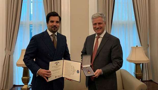The US National Security Adviser Ambassador Robert O'Brien hands over the medal to HE the Ambassador of  Qatar to the United States Sheikh Meshaal bin Hamad Al-Thani.