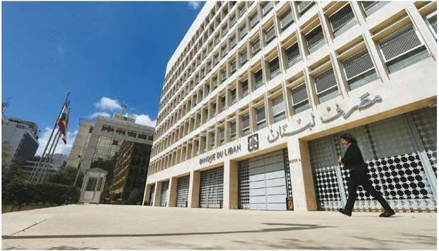 A woman walks outside of Lebanonu2019s central bank building in Beirut (file). The Swiss attorney generalu2019s office said it had requested legal assistance from Lebanon in the context of a probe into u201caggravated money launderingu201d and possible embezzlement tied to the Lebanese central bank.
