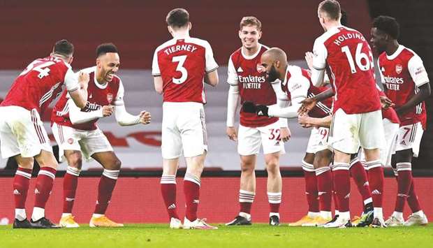 Arsenalu2019s striker Pierre-Emerick Aubameyang (second left) celebrates with teammates after scoring against Newcastle United in London on Monday. (AFP)