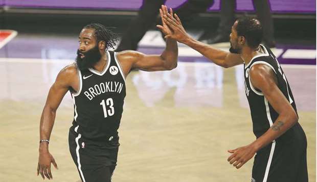 Brooklyn Nets shooting guard James Harden (left) and power forward Kevin Durant high five during the fourth quarter against the Milwaukee Bucks at Barclays Center in Brooklyn. (USA TODAY Sports)