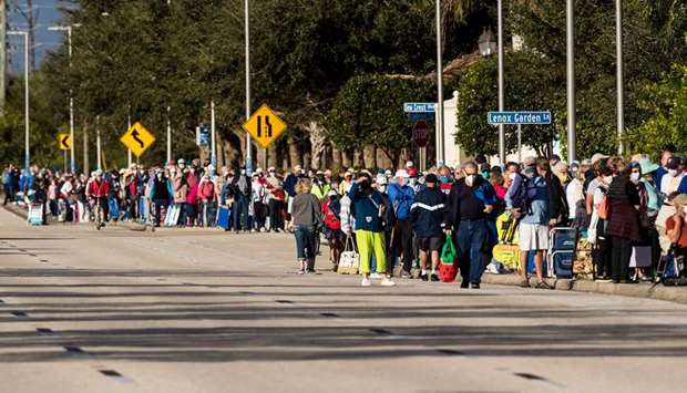 Hundreds wait in line at Lakes Park Regional Library to receive the Covid-19 vaccine in Fort Myers, Florida
