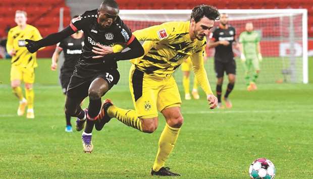 Dortmundu2019s Mats Hummels (right) and Leverkusenu2019s Moussa Diaby vie for the ball during the Bundesliga match in Leverkusen, western Germany, on Tuesday. (AFP)