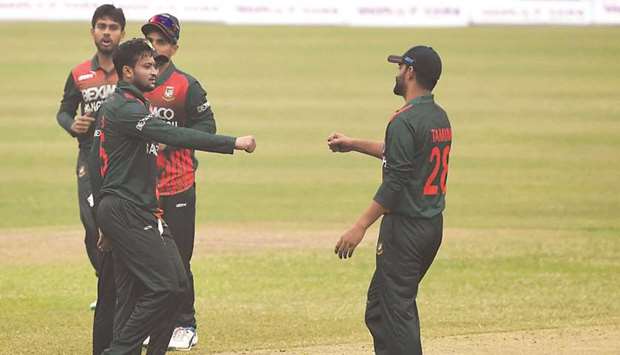 Bangladeshu2019s Shakib Al Hasan (left) celebrates with teammates after dismissing West Indiesu2019 Alzarri Joseph (not in picture) during the first one-day international in Dhaka yesterday. (AFP)