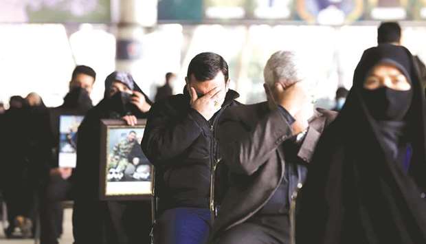 Mourners react during a ceremony to mark the one year anniversary of the killing of senior Iranian military commander General Qassem Soleimani in a US attack, in Tehran, Iran.