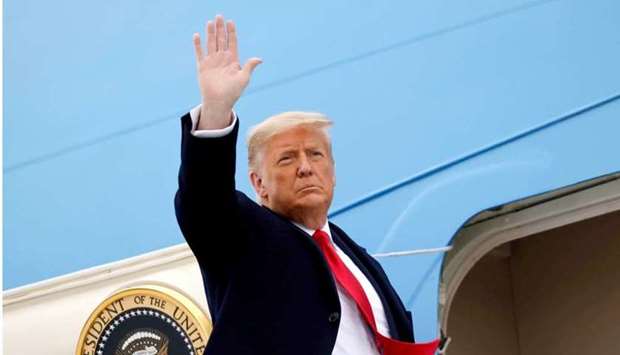 US President Donald Trump salutes as he boards Air Force One at after visiting the US-Mexico border wall, in Harlingen, Texas, January 12.