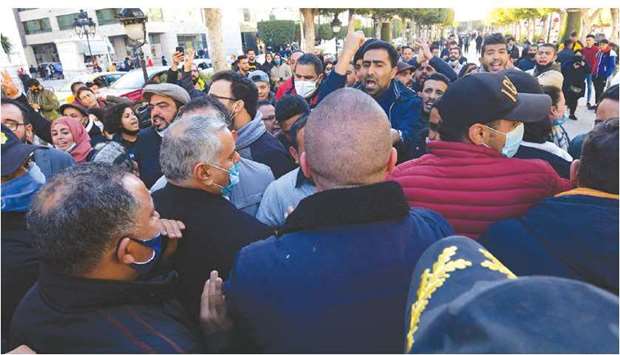 Tunisian protesters take part in an anti-government demonstration on the Habib Bourguiba avenue in the capital Tunis, yesterday.