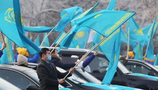 People wave national flags during a pre-election rally in Almaty, Kazakhstan