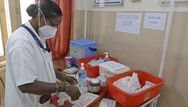 A health official prepares a vaccine kit as she takes part in dry run or a mock drill for Covid-19 coronavirus vaccine delivery at a primary health centre in Hyderabad