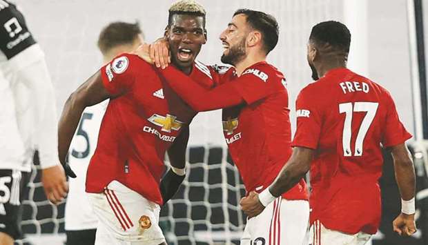 Manchester Unitedu2019s Paul Pogba (left) celebrates with Bruno Fernandes after scoring against Fulham in the Premier League at Craven Cottage in London on Wednesday night. (AFP)