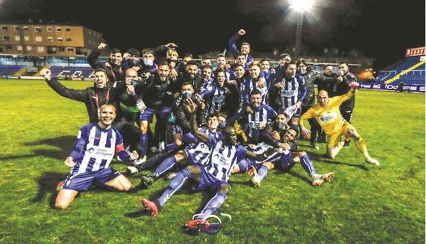 Third-tier side Alcoyano players celebrate after their win over Real Madrid in the Copa del Rey on Wednesday night.
