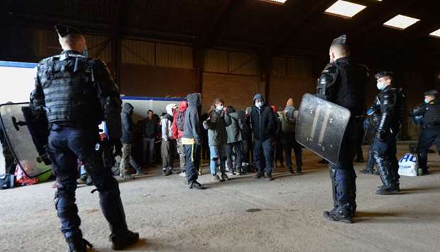 French Gendarmes evacuate the last partygoers who attended a rave in a disused hangar in Lieuron about 40km south of Rennes, on January 2, 2021