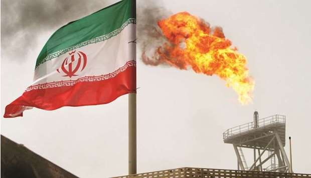 A gas flare on an oil production platform in the Soroush oil fields is seen alongside an Iranian flag in the Gulf (file). Iranu2019s oil exports have climbed in recent months and sales of petroleum products to foreign buyers reached record highs despite US sanctions, the oil minister said yesterday.