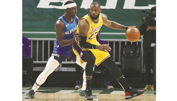 LA Lakersu2019 LeBron James (right) is defended by Milwaukee Bucksu2019 Jrue Holiday during the game at the Bradley Center in Milwaukee, Wisconcin, United States, on Thursday. (USA TODAY Sports)