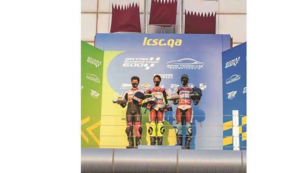 The QSSP 300 class winner Hamad al-Sahouti (centre), runner-up Yousef al-Darwish (left) and third-placed Saad al-Harqan pose on the podium.