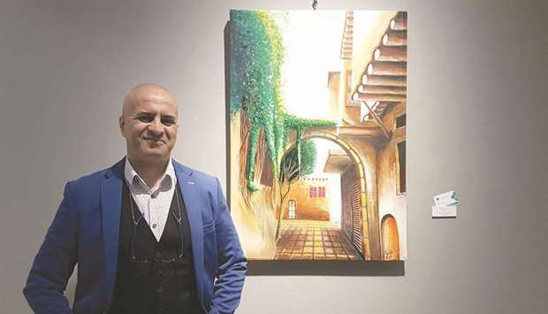 Syrian artist al-Bizri and one of his works at Katara Building 18. PICTURES: Joey Aguilarrnrn