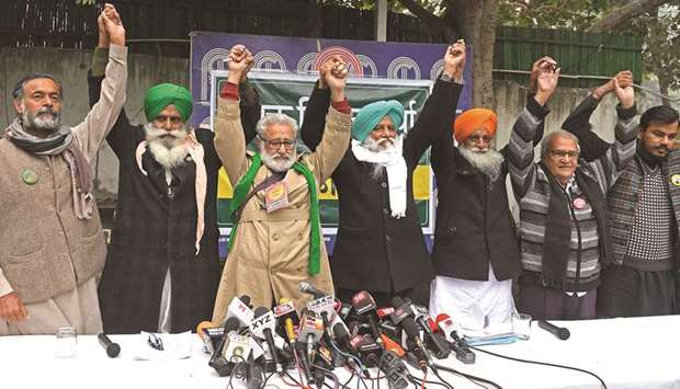 The farmer leaders raise hands to show solidarity towards protesting farmers against the central governmentu2019s recent agricultural reforms during a joint press conference in New Delhi, yesterday.