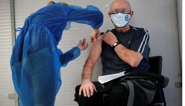 An elderly man, over 75 years of age, receives a dose of the Pfizer-BioNTech Covid-19 vaccine at a coronavirus disease vaccination center in Guingamp, France