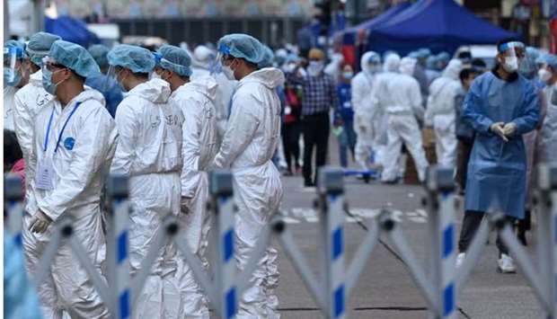 Health workers prepare to conduct testing in the Jordan area of Hong Kong on January 23, 2021, after thousands were ordered to stay in their homes for the city's first Covid-19 coronavirus lockdown as authorities battle an outbreak in one of its poorest and most densely packed districts.