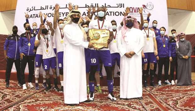 Players and officials of Police team celebrate as Qatar Volleyball Association President Ali Ghanem al-Kuwari handed over the winnersu2019 shield to their captain yesterday.