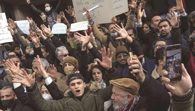 Tunisian protesters gesture as they shout slogans during an anti-government demonstration in the capital Tunis, yesterday.