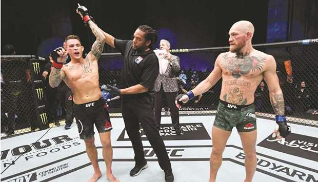Dustin Poirier celebrates after his knockout victory over Conor McGregor (right) of Ireland in a lightweight fight during the UFC 257 event inside Etihad Arena on UFC Fight Island in Abu Dhabi. (USA TODAY Sports)