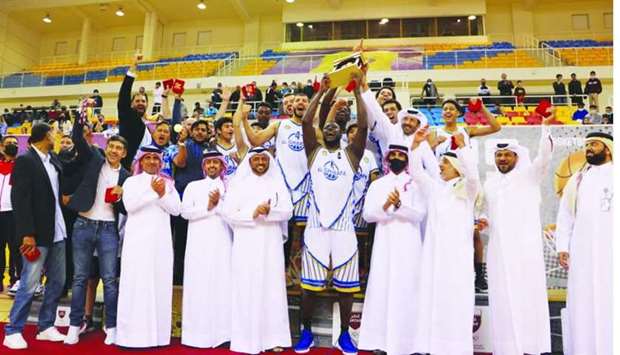 Al Gharafa players and officials celebrate with the winnersu2019 trophy and Qatar Basketball Federation officials after beating Al Shamal in the Qatar Menu2019s League final at the Al Gharafa Indoor Hall