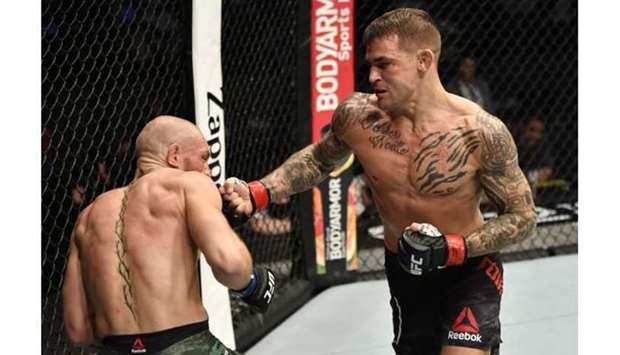 Dustin Poirier punches Conor McGregor of Ireland in a lightweight fight.