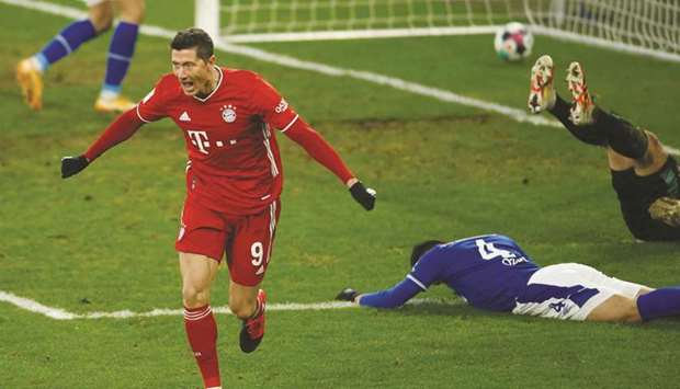 Bayern Munichu2019s Robert Lewandowski celebrates scoring a goal during the Bundesliga match against Schalke 04 in Gelsenkirchen, Germany, yesterday. (AFP)