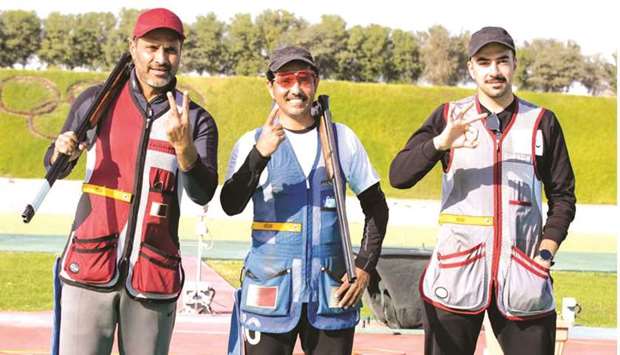 First-placed Masoud Saleh Hamad (centre), second-placed Nasser Saleh al-Attiyah (left) and third-placed Ali Ahmed al-Ishaq pose on the menu2019s skeet podium of Qatar Shooting and Archery Cup at the Losail Shooting Range.