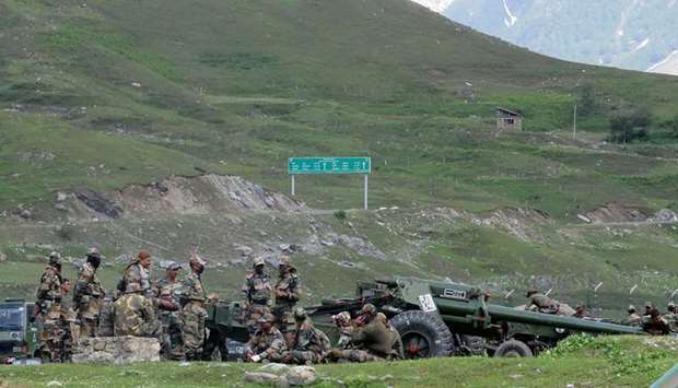 (file photo) Indian army soldiers rest next to artillery guns at a makeshift transit camp before heading to Ladakh, near Baltal, southeast of Srinagar.