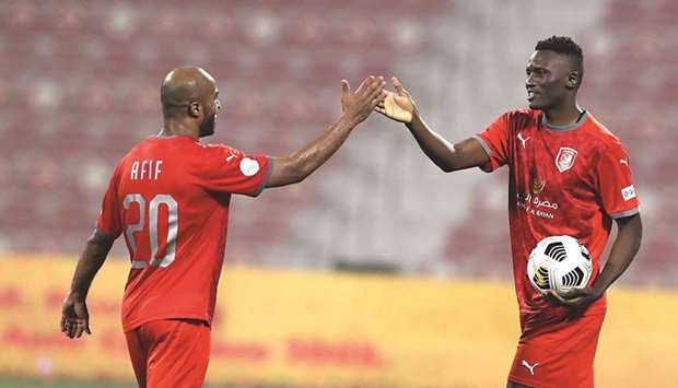 Al Duhailu2019s hat-trick hero Michael Olunga (right) celebrates with Ali Afif after their victory over Al Ahli in the last 16 match of the Amir Cup at the Grand Hamad Stadium.