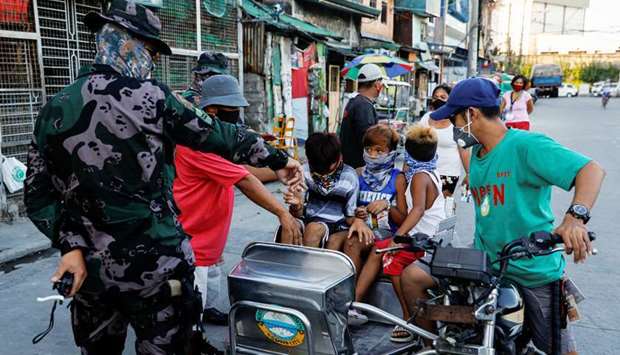 Children whom authorities say violated quarantine restrictions, board a rickshaw to go to a local government hall for a lecture on safety precautions against coronavirus disease (Covid-19), in Navotas, Metro Manila