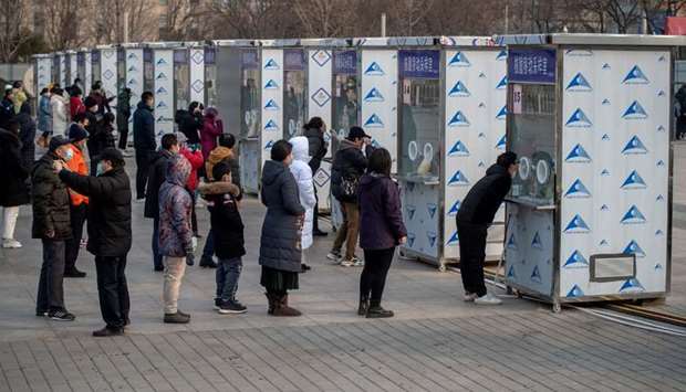 People line up to be tested for the Covid-19 coronavirus in Beijing part of a drive to test two mill