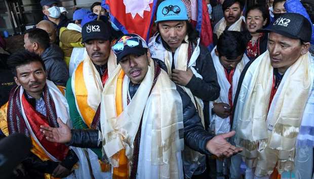 Nepali mountaineer Nirmal Purja (C) talks to the media along with his team at the Tribhuvan International airport after becoming the first to summit Pakistan's K2 mountain in winter, in Kathmandu