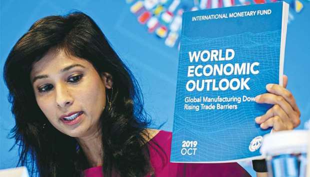 Gita Gopinath, IMFu2019s chief economist, holds up a copy of the World Economic Outlook while speaking at a news conference in Washington, DC (file).  u201cMuch now depends on the outcome of this race between a mutating virus and vaccines to end the pandemic, and on the ability of policies to provide effective support until that happens,u201d Gopinath wrote in a blog post accompanying the World Economic Outlook yesterday.