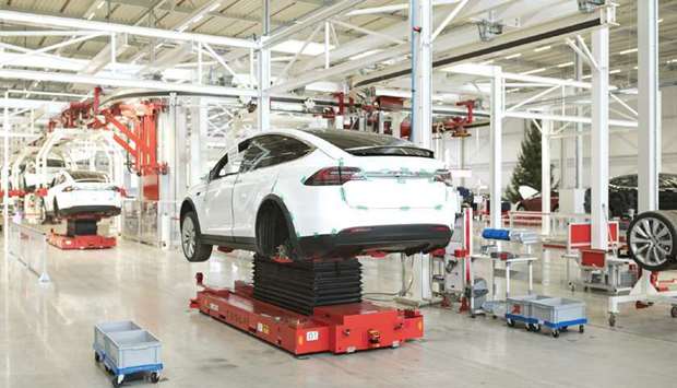 A Tesla Model X SUVs on hydraulic platforms during assembly for the European market at the Tesla Motors factory in Tilburg, Netherlands. The 27-nation EU plans to slash greenhouse gas emissions from transport under the European Green Deal, an ambitious economic overhaul aimed at reaching climate neutrality by 2050.