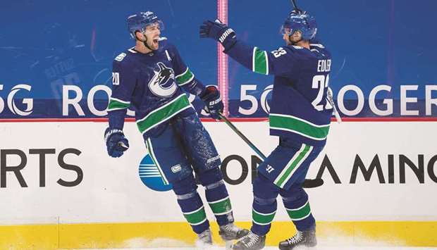 Vancouver Canucks forward Brandon Sutter (left) celebrates his hat-trick against the Ottawa Senators with teammate Alexander Edler at the Rogers Arena in Vancouver. (USA TODAY Sports)