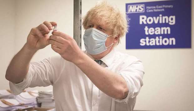 SPOTLIGHT: Prime Minister Boris Johnson sees how a dose of the Oxford/AstraZeneca Covid 19 vaccine is prepared for a mobile vaccination centre during a visit to Barnet FCu2019s ground at The Hive, north London, which is being used as a coronavirus vaccination centre on Monday. (AFP)