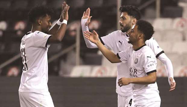 Al Saddu2019s Youssef Abdel Razaq (left) celebrates with teammates after scoring against Muaither in the last 16 match of the Amir Cup at the Jassim Bin Hamad Stadium yesterday.