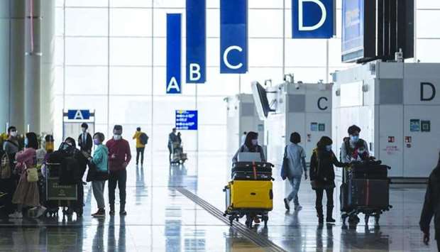 Travellers walk through the departures hall at the Hong Kong International Airport. The aviation sector has been hit particularly hard by coronavirus, which has disrupted travel, the transportation industry overall, and operations of airlines and airports globally.