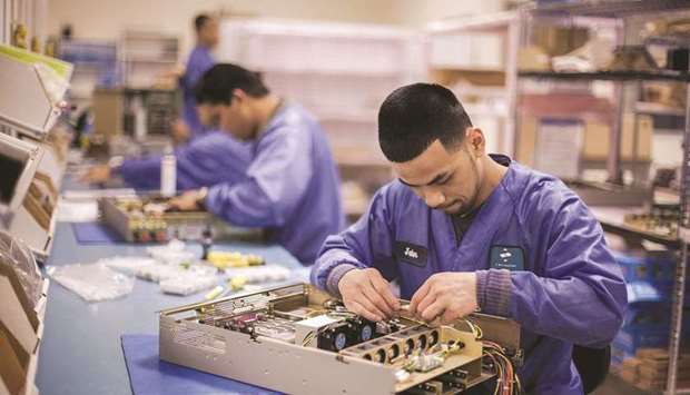 Employees assemble servers at the Z Microsystems manufacturing facility in San Diego, California. Demand has shifted away from services like travel and hospitality towards goods like motor vehicles, electronics and medical equipment during the Covid-19 pandemic.