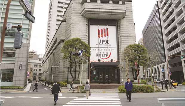 Pedestrians walk by the Tokyo Stock Exchange building, operated by Japan Exchange Group. The Nikkei 225 closed 0.3% up at 28,635.21 points yesterday.