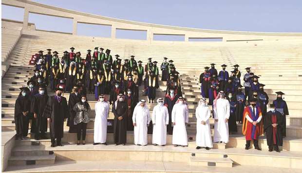 Dignitaries and officials with graduates.