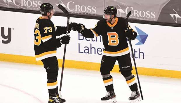 Boston Bruins right wing Craig Smith (right) celebrates with defenseman Charlie McAvoy after scoring the game winning goal against the Pittsburgh Penguins during an overtime period at the TD Garden in Boston. (USA TODAY Sports)